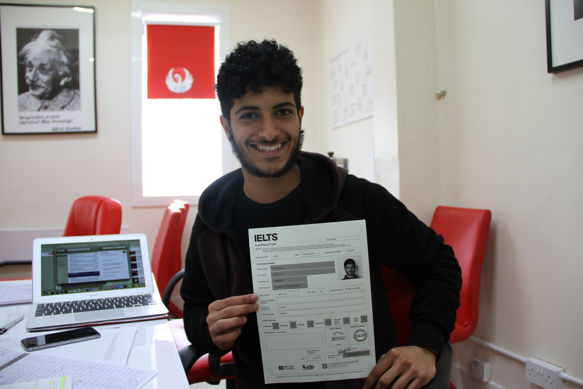 a boy with showing IELTS application form in hand