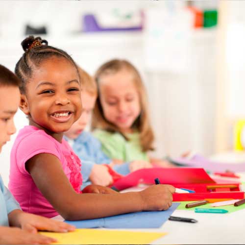 a kid smiling in the pre school class